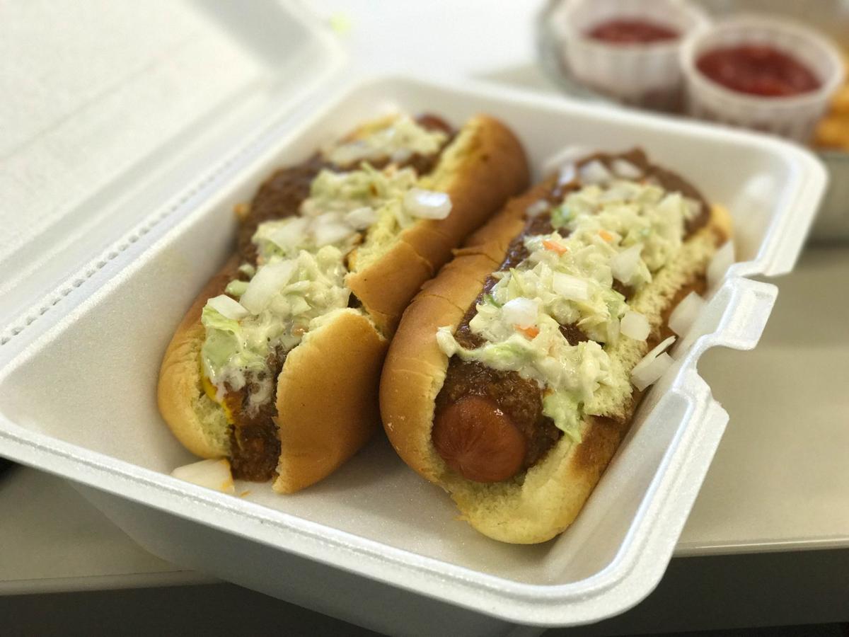 2 hot dogs with coleslaw on top.