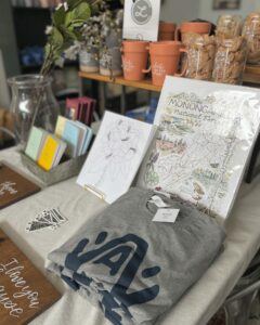 Home goods and t-shirts for sale at Kin Ship Goods and Base Camp Printing Company.